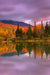 Peak fall foliage reflected on a lake - White Mountains, New Hampshire